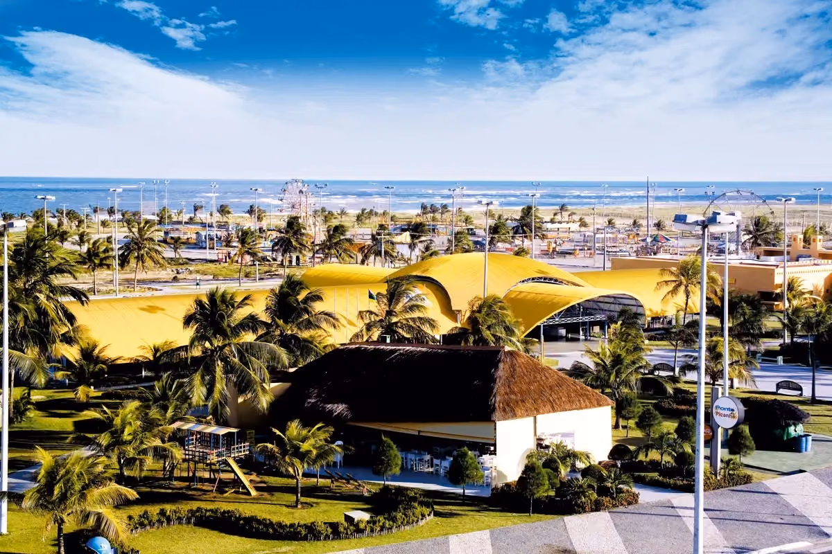 Vista aérea da orla de Atalaia em Aracaju, com barracas de praia e área de lazer